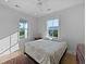 Sunlit bedroom showcasing hardwood floors, double windows, and neutral tones at 48 Aiken St, Charleston, SC 29403