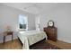 Bright bedroom with hardwood floors, double windows, and classic wood furnishings at 48 Aiken St, Charleston, SC 29403