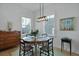 Cozy dining room featuring a round table, wooden chairs, and natural light from nearby windows at 48 Aiken St, Charleston, SC 29403