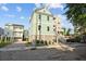 Home exterior featuring an open parking area, a two-car garage, and inviting balconies at 48 Aiken St, Charleston, SC 29403
