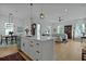 Open-concept kitchen with island, breakfast bar, stainless appliances, and views into the living and dining areas at 48 Aiken St, Charleston, SC 29403