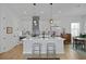 Modern kitchen with sleek white cabinets, stainless steel appliances, an island, and breakfast bar at 48 Aiken St, Charleston, SC 29403