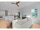 Open-concept living room showcasing hardwood floors, a ceiling fan, and seamless flow to the kitchen at 48 Aiken St, Charleston, SC 29403