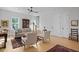 Inviting living room with hardwood floors, a ceiling fan, staircase, and classic furniture at 48 Aiken St, Charleston, SC 29403