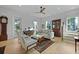 Cozy living room with neutral tones, hardwood floors, a ceiling fan, and an antique hutch at 48 Aiken St, Charleston, SC 29403