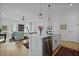 Open-concept living room with view of kitchen, hardwood floors, and neutral tones; bright and airy at 48 Aiken St, Charleston, SC 29403