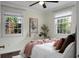 Bedroom with white walls, hardwood floors, and a view of the trees outside the window at 4810 Parkside Dr, North Charleston, SC 29405