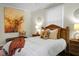 Cozy bedroom featuring a wooden headboard, a large painting and decorative pillows and blanket at 4810 Parkside Dr, North Charleston, SC 29405