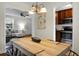 Open dining area showcasing a wood table, light fixture, and views into the living room and kitchen at 4810 Parkside Dr, North Charleston, SC 29405