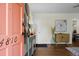 Inviting entryway with a light-colored wall, stylish console table, and a vibrant peach-colored front door, leading into a cozy home at 4810 Parkside Dr, North Charleston, SC 29405