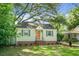 Inviting front exterior of a charming home with green shutters and a well-kept yard at 4810 Parkside Dr, North Charleston, SC 29405