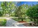 Residential front yard featuring a small palm tree in a brick planter and a sprawling lawn with mature trees at 4810 Parkside Dr, North Charleston, SC 29405