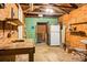 Garage with exposed rafters and worktable plus refrigerator and wooden shelves at 4810 Parkside Dr, North Charleston, SC 29405