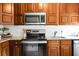 Updated kitchen featuring stainless steel appliances, granite countertops, and wooden cabinetry at 4810 Parkside Dr, North Charleston, SC 29405