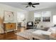 Bright living area with hardwood floors, a sectional sofa, and large windows, seamlessly connecting to the dining area for easy entertaining at 4810 Parkside Dr, North Charleston, SC 29405