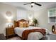 Cozy main bedroom with ceiling fan, warm decor, two windows offering natural light at 4810 Parkside Dr, North Charleston, SC 29405
