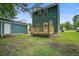 Exterior view of backyard featuring a wooden deck and green siding at 4818 Buttercup Way, Summerville, SC 29485
