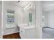 Bathroom with vinyl flooring, single sink vanity and large mirror at 4818 Buttercup Way, Summerville, SC 29485