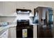Bright kitchen features a modern black range and stainless steel refrigerator at 4818 Buttercup Way, Summerville, SC 29485