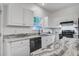 Bright kitchen featuring granite countertops, stainless steel appliances, and white cabinetry at 4818 Buttercup Way, Summerville, SC 29485