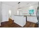 Bright kitchen featuring a breakfast bar, white cabinets, stainless steel appliances, and hardwood floors at 4818 Buttercup Way, Summerville, SC 29485