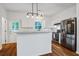 Well-lit kitchen with stainless steel appliances, white cabinets, and a marble countertop island at 4818 Buttercup Way, Summerville, SC 29485