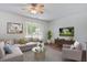 Inviting living room featuring a plush sectional sofa, patterned rug, and large window with natural light at 4818 Buttercup Way, Summerville, SC 29485