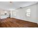 Open concept living area with hardwood floors, connecting seamlessly to the kitchen with bright windows at 4818 Buttercup Way, Summerville, SC 29485