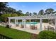 Community pool with pergola, tables, and chairs surrounded by lush landscaping at 4818 Buttercup Way, Summerville, SC 29485