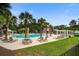 Community pool surrounded by tropical landscaping and sunbathing lounge chairs at 4818 Buttercup Way, Summerville, SC 29485