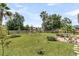 Spacious backyard with lush green grass, a swing set, and mature trees, perfect for outdoor activities at 5257 Mulholland Dr, Summerville, SC 29485