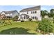Spacious backyard with lush green lawn, patio area, swing set, and established landscaping at 5257 Mulholland Dr, Summerville, SC 29485