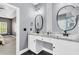 Double vanity bathroom with two sinks, black hardware, gray walls, and tiled floors at 5257 Mulholland Dr, Summerville, SC 29485