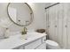 Clean bathroom featuring a white vanity with gold faucet, a round mirror, and a shower with curtain at 5257 Mulholland Dr, Summerville, SC 29485
