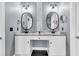 Double vanity bathroom with two oval mirrors, black hardware, and tiled floors at 5257 Mulholland Dr, Summerville, SC 29485