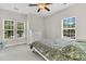 Bright bedroom featuring two large windows, a ceiling fan, and a floral-patterned bedspread at 5257 Mulholland Dr, Summerville, SC 29485