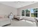 Bright bedroom featuring two beds, a dresser, neutral paint, and natural light from large windows at 5257 Mulholland Dr, Summerville, SC 29485
