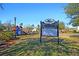 Entrance to the community featuring a wooden playground with slides and swings for Gathering fun at 5257 Mulholland Dr, Summerville, SC 29485