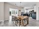 Open-concept dining area connected to a modern kitchen and a sunroom, creating a seamless flow for entertaining at 5257 Mulholland Dr, Summerville, SC 29485