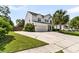 Spacious driveway leading to a two-car garage, complemented by lush green landscaping and a fenced yard at 5257 Mulholland Dr, Summerville, SC 29485