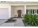 Charming front door with decorative plants, a welcoming entrance, and an attached garage at 5257 Mulholland Dr, Summerville, SC 29485