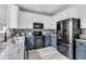 Stylish kitchen with stainless steel appliances, granite countertops, and a combination of white and blue cabinets at 5257 Mulholland Dr, Summerville, SC 29485