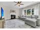 Inviting living room with a cozy fireplace, large windows, and comfortable gray sectional sofa at 5257 Mulholland Dr, Summerville, SC 29485