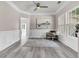 Tasteful living room featuring gray floors, wainscoting, and a chair by the window at 5257 Mulholland Dr, Summerville, SC 29485