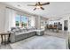 Open-concept living room with a gray sectional, lots of natural light, and views into the kitchen at 5257 Mulholland Dr, Summerville, SC 29485