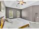 Another view of the comfortable main bedroom with neutral paint, a ceiling fan, and natural light at 5257 Mulholland Dr, Summerville, SC 29485