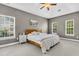 Comfortable main bedroom with neutral paint, a ceiling fan, and natural light from multiple windows at 5257 Mulholland Dr, Summerville, SC 29485