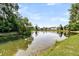 Scenic view of a serene pond reflecting the blue sky and surrounding greenery, creating a tranquil atmosphere at 5257 Mulholland Dr, Summerville, SC 29485