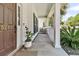 Inviting front porch with white pillars, a cozy space for relaxing, and a beautifully landscaped entrance at 5257 Mulholland Dr, Summerville, SC 29485