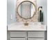 Stylish powder room featuring a round mirror, floral wallpaper, white vanity, and elegant gold fixtures at 5257 Mulholland Dr, Summerville, SC 29485